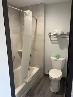 a bathroom with a toilet and a tub and a shower at Motel 6-San Bernardino, CA - North in Serrano Village
