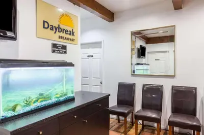 a large fish tank in a room with chairs at Days Inn by Wyndham Castaic Six Flags Magic Mountain in Castaic