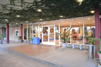 a store front with potted plants in a building at Ontario Airport Inn in Ontario