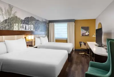a hotel room with two beds and a desk and a computer at Hilton Garden Inn Los Angeles / Hollywood in Los Angeles