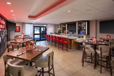 a restaurant with tables and chairs and a bar at Hilton Garden Inn Los Angeles / Hollywood in Los Angeles