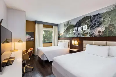 a hotel room with two beds and a tv at Hilton Garden Inn Los Angeles / Hollywood in Los Angeles