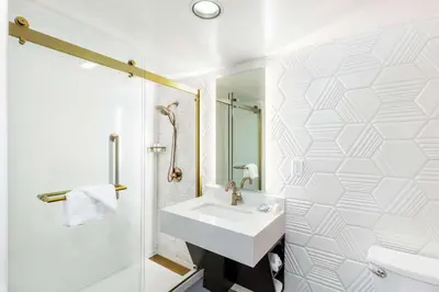 a white bathroom with a sink and a shower at Hilton Garden Inn Los Angeles / Hollywood in Los Angeles