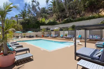 a swimming pool with lounge chairs and a resort at Hilton Garden Inn Los Angeles / Hollywood in Los Angeles