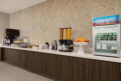 a kitchen with a counter with a refrigerator at La Quinta Inn & Suites by Wyndham San Bernardino in San Bernardino