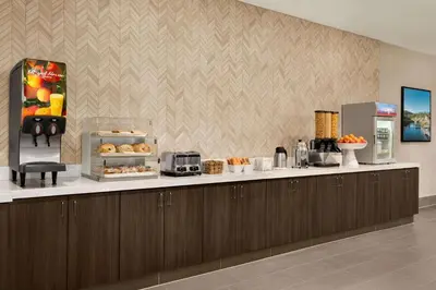 a kitchen with a counter with aasteryasteryasteryasteryasteryasteryasteryasteryastery at La Quinta Inn & Suites by Wyndham San Bernardino in San Bernardino