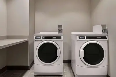 a washing machine and a dryer in a kitchen at La Quinta Inn & Suites by Wyndham San Bernardino in San Bernardino
