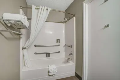a bathroom with a bath tub with a shower curtain at Motel 6-Santa Ana, CA in Santa Ana