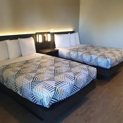 two beds sitting next to each other in a room at Motel 6-Bellflower, CA - Los Angeles in Bellflower