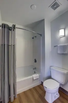 a bathroom with a toilet and a tub and a shower at Motel 6-Bellflower, CA - Los Angeles in Bellflower