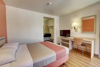a hotel room with a bed and a desk at Motel 6-Bellflower, CA - Los Angeles in Bellflower