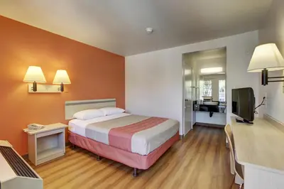 a hotel room with a bed and a television at Motel 6-Bellflower, CA - Los Angeles in Bellflower