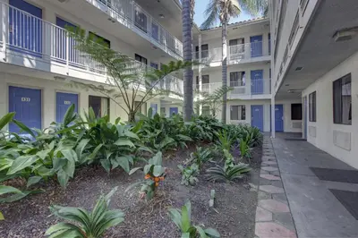 a courtyard of an apartment building with plants at Motel 6-Bellflower, CA - Los Angeles in Bellflower