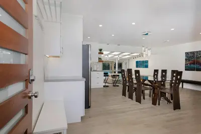 a kitchen and dining room with a table and chairs at Oasis with pool and music studio by BENVENU in Los Angeles