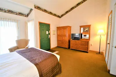 a bedroom with a bed and a television in it at Lagonita Lodge in Big Bear Lake