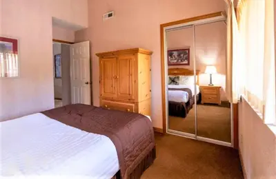 a hotel room with a bed and a mirror at Lagonita Lodge in Big Bear Lake