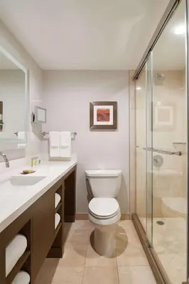 a bathroom with a toilet and a glass shower at DoubleTree by Hilton Torrance - South Bay in Torrance