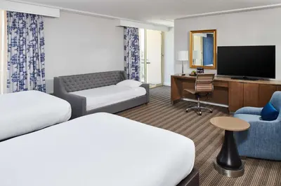 a hotel room with two beds and a television at DoubleTree by Hilton Torrance - South Bay in Torrance