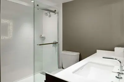 a bathroom with a shower and a sink and a toilet at Hilton Woodland Hills/ Los Angeles in Woodland Hills