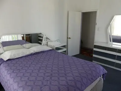 a bedroom with a purple bed and a window at Wilshire Orange Hotel in Los Angeles
