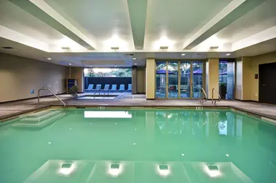 a swimming pool with blue water in a hotel room at Home2 Suites by Hilton Los Angeles Montebello in Montebello