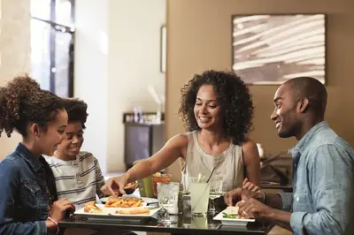 a group of people sitting around a table eating food at DoubleTree by Hilton Monrovia - Pasadena Area in Monrovia