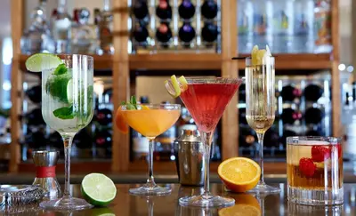 a group of cocktails in wine glasses on a bar at The Beverly Hilton in Los Angeles