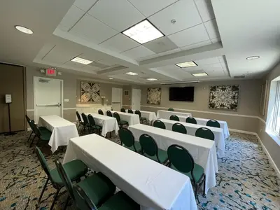 a conference room with white tables and green chairs at Hilton Garden Inn Calabasas in Calabasas