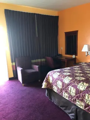 a hotel room with a bed and a chair at Encore Motel Near Marina Del Rey, Culver City & Venice in Los Angeles