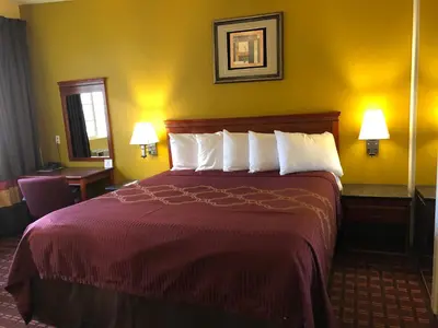 a hotel room with a large bed with white pillows at Encore Motel Near Marina Del Rey, Culver City & Venice in Los Angeles