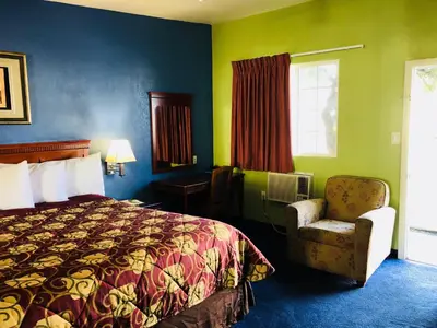 a hotel room with a bed and a chair at Encore Motel Near Marina Del Rey, Culver City & Venice in Los Angeles