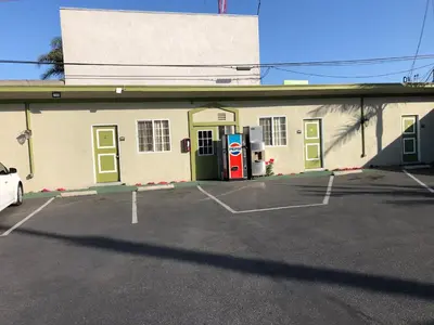 a building with a gas pump in a parking lot at Encore Motel Near Marina Del Rey, Culver City & Venice in Los Angeles