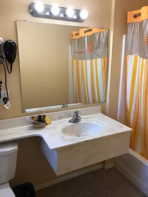a bathroom with a sink and a large mirror at Encore Motel Near Marina Del Rey, Culver City & Venice in Los Angeles