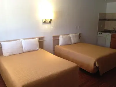 a hotel room with two beds in a room at Mount-N-Lake Motel in Wofford Heights