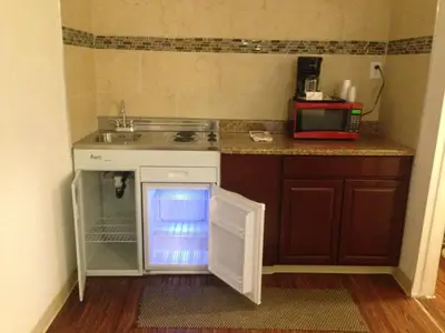 a small kitchen with a sink and a microwave at Mount-N-Lake Motel in Wofford Heights
