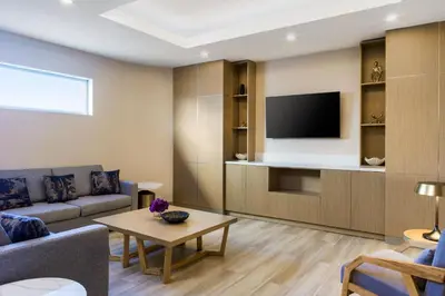 a living room with a couch and a tv at Delta Hotels by Marriott Ontario Airport in Ontario