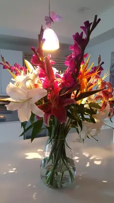 a glass vase filled with flowers on a table at Heaven's Best Kept Secret 4 Min From The Sea in Pacific Palisades