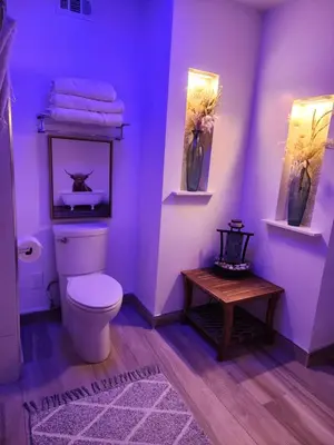 a purple bathroom with a toilet and a table at Heaven's Best Kept Secret 4 Min From The Sea in Pacific Palisades