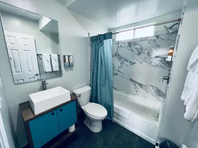 a bathroom with a sink and a toilet and a shower at Harbor Inn in Harbor City