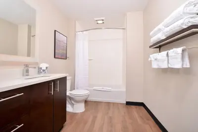 a bathroom with a white toilet and a shower at TownePlace Suites by Marriott Ontario Chino Hills in Chino Hills