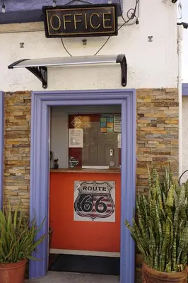 a front door of a coffee shop with a sign above it at Route 66 Motel - Rialto in Rialto