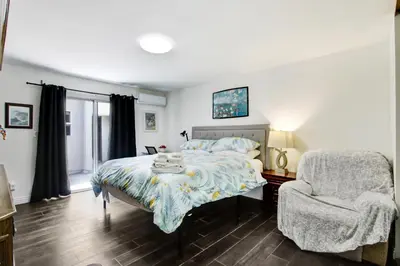 a bedroom with a bed and a chair at Beautiful House Fantastic view in Azusa in Azusa