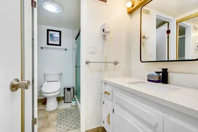 a bathroom with a toilet and a sink and a mirror at Beautiful House Fantastic view in Azusa in Azusa