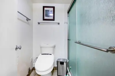 a bathroom with a toilet and a glass door at Beautiful House Fantastic view in Azusa in Azusa