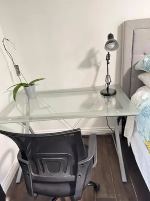 a glass desk with a lamp and a chair at Beautiful House Fantastic view in Azusa in Azusa