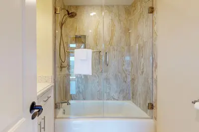 a bathroom with a bath tub and a shower at Mountain Top Chalet in Lake Arrowhead