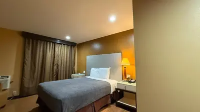 a hotel room with a bed and a desk at Redondo Beach Inn-LAX in Gardena