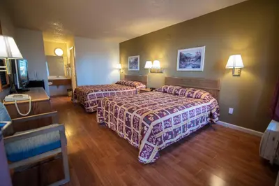 a hotel room with two beds and a television at National 9 Inns in Buttonwillow