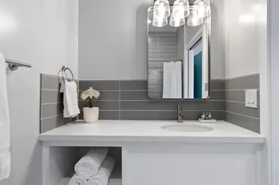 a bathroom with a sink and a mirror at Sea Sprite Beach Club in Hermosa Beach
