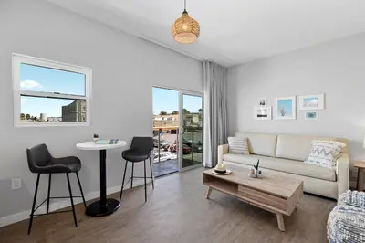 a living room with a couch and a table at Sea Sprite Beach Club in Hermosa Beach